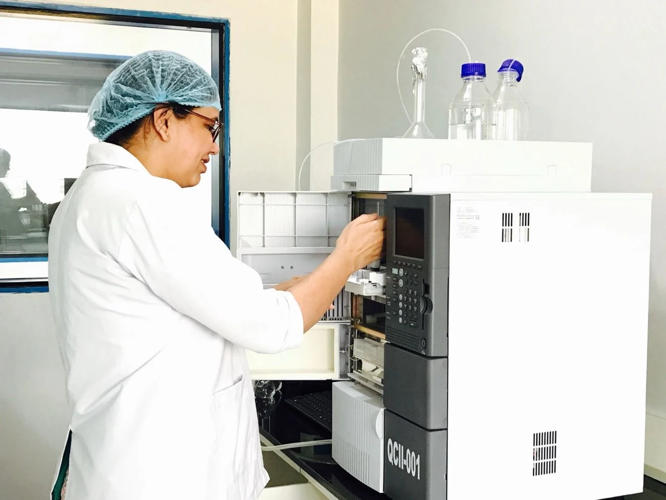 Analyst loading a laboratory instrument